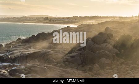 Lumière d'après-midi atmosphérique avec des embruns sur les rochers à Port Elliot en Australie du Sud, regardant vers Rocky Bay et Green Bay Banque D'Images
