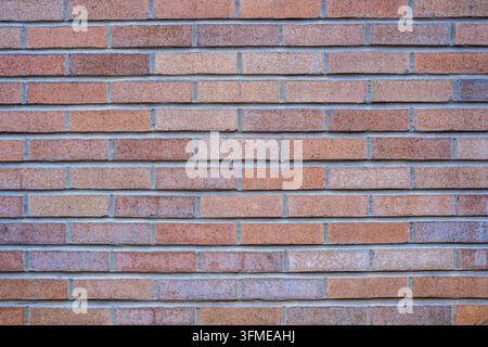 Fond d'un mur de briques rougeâtres Banque D'Images