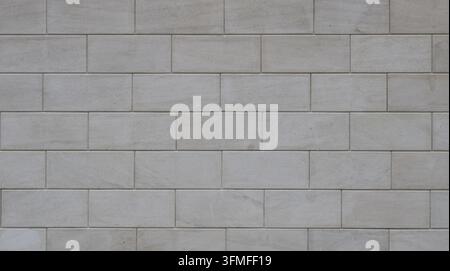 Texture de maçonnerie moderne en blocs rectangulaires. Fond mural lisse gris clair avec des joints fins. Motif minimaliste sans couture. Banque D'Images
