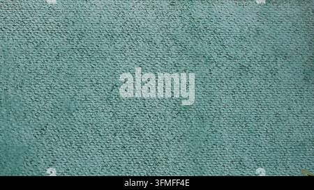 Texture d'un mur vert texturé avec du plâtre décoratif. Un fond rugueux présentant une finition à grains fins, des gouttelettes et une coloration irrégulière. Banque D'Images