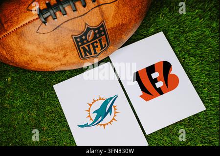 FLORIDE, ÉTATS-UNIS, 7 SEPTEMBRE 2026 : Concept de match NFL des Miami Dolphins contre les Cincinnati Bengals avec les logos des équipes imprimés sur du papier blanc à côté d'un cuir Banque D'Images