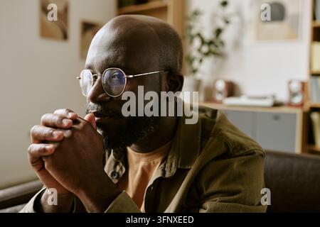 Homme noir pensif assistant à une séance de thérapie dans un cabinet de psychologie Banque D'Images
