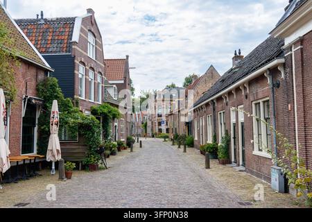 Rue pavée avec des maisons en briques à Alkmaar, Pays-Bas Banque D'Images