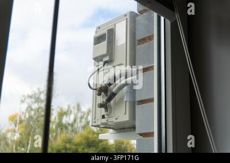 Unité extérieure de climatisation montée sur la façade d'un bâtiment avec balcon Banque D'Images
