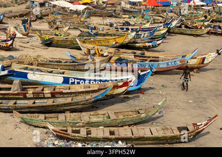 Rangées de bateaux de pêche traditionnels colorés alignés sur la plage de sable, Région centrale, Cape Coast, Ghana Banque D'Images