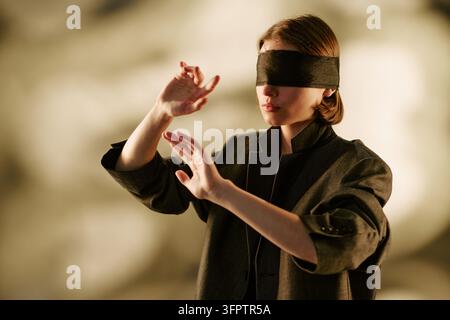 Femme aveugle tendant la main vers l'avant pour le concept d'incertitude Banque D'Images