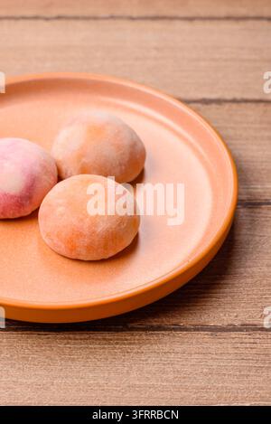 Dessert mochi japonais asiatique dans diverses couleurs et saveurs de fruits. Dessert mochi comme arrière-plan alimentaire pour votre design Banque D'Images