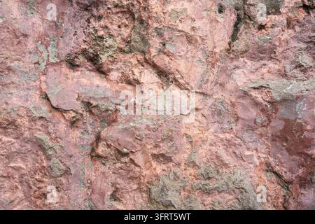 Texture de mur en stuc rose érodé avec surface craquelée et caractère vintage rustique Banque D'Images