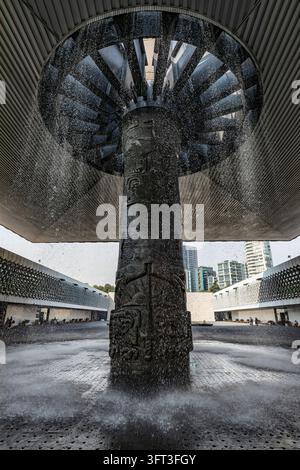 L'eau cascade du toit en forme de parapluie de la fontaine El Paraguas autour de sa colonne en bronze au Musée national d'anthropologie, Mexico City, Mexique Banque D'Images