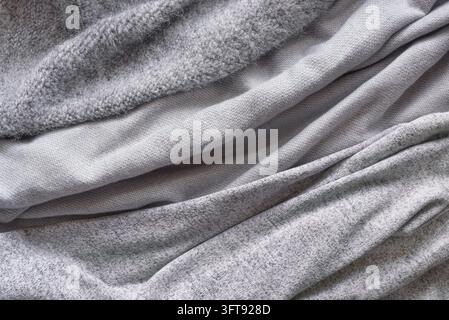 Diverses tissus tricotés gris, textures douces et chaudes en cachemire ou en laine pour l'automne et l'hiver. Conception de concept hygge et confortable pour la maison. Banque D'Images