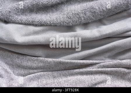 Diverses tissus tricotés gris, textures douces et chaudes en cachemire ou en laine pour l'automne et l'hiver. Conception de concept hygge et confortable pour la maison. Banque D'Images