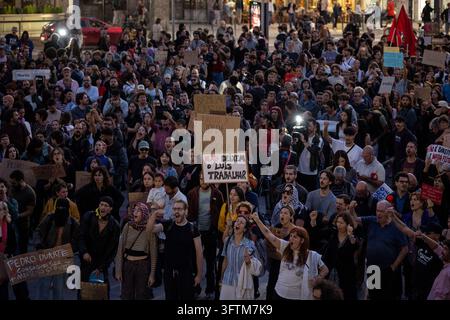 Une foule se rassemble lors d'une manifestation pour les droits du logement et d'un protestation contre la violence policière à la Praça D. João I à Porto, au Portugal. Les manifestants tiennent des pancartes et scandent des slogans lors de l'assemblée publique organisée après les affrontements entre la police et les participants d'un camp de protestation pour le logement dans la ville. 15 octobre 2026. Banque D'Images