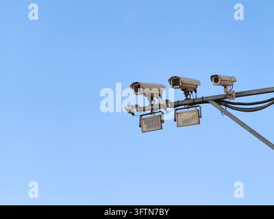 Plusieurs caméras de surveillance CCTV et projecteurs montés sur un poteau métallique, capturant la surveillance extérieure et la surveillance de sécurité pour la sécurité publique, Banque D'Images