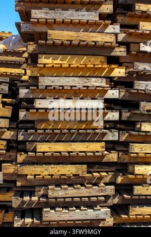 Pile de palettes en bois usées à l'extérieur. Banque D'Images