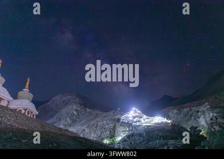 Vue du monastère de Diskit illuminé niché dans les montagnes escarpées de la vallée de Nubra sous un ciel nocturne étoilé avec la Voie lactée visible, Disk Banque D'Images