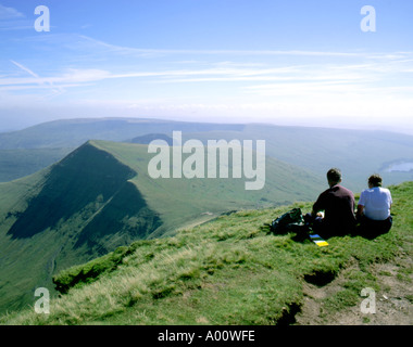 Couple assis sur le sommet du pen y fan parc national de Brecon Beacons au Pays de Galles Banque D'Images