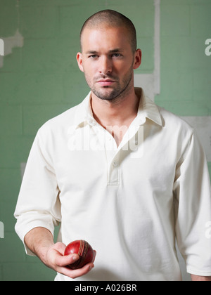 Le Cricket player holding ball, portrait
