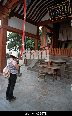 Les jeunes femmes japonaises dans la prière à un temple japonais Japon Nara prefectue Banque D'Images