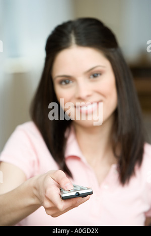 Young woman with remote control Banque D'Images