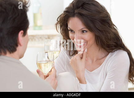 Couple toasting with white wine Banque D'Images