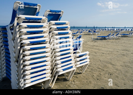 Transats SUR LA PLAGE EN FACE DE LA VILLE DE LARNAKA BOUTIQUES ET RESTAURANTS. Chypre Banque D'Images