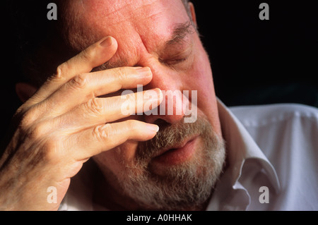 USA Close-up Man avec sa main à sa tête fatiguée concerné montrant la douleur souffrance malheureux Banque D'Images