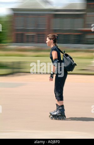 Une femme le roller dans un parc à Londres. Banque D'Images