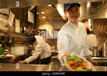Close up of a waitress holding a plate of food Banque D'Images