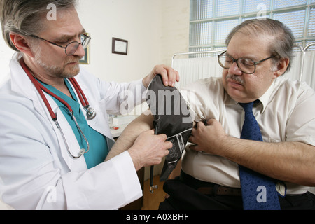 Le médecin vérifie la pression artérielle de son patient lors d'un examen dans le cabinet, clinique ou hôpital. Banque D'Images
