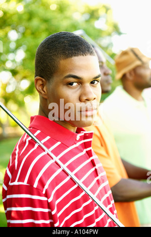 Teenage African boy playing golf Banque D'Images