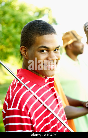 Teenage African boy playing golf Banque D'Images