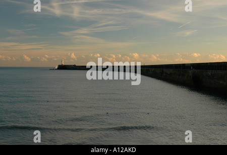 Newhaven mur du port et le phare au coucher du soleil. Banque D'Images