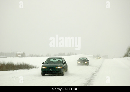 La conduite sur une route rurale route secondaire au Québec Canada pendant une tempête de neige, la route est glissante et neige Banque D'Images