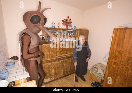 Vieille Femme et un homme de grande taille en costume de moustiques dans une vieille cuisine Banque D'Images