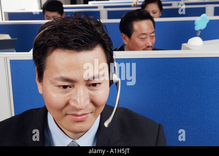 Close-up of a businessman wearing headsets Banque D'Images