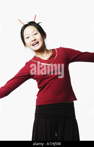 Portrait of a young man standing with her arms outstretched Banque D'Images