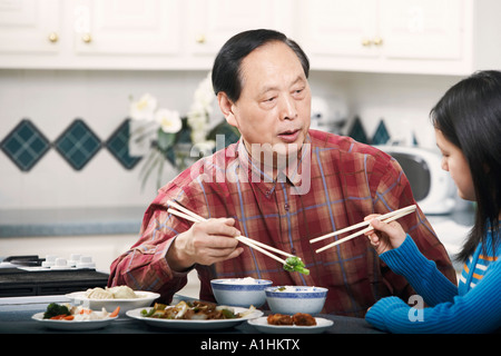 Grand-père et sa petite fille assise à une table Banque D'Images