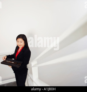 Portrait of a businesswoman holding un boulier and smiling Banque D'Images