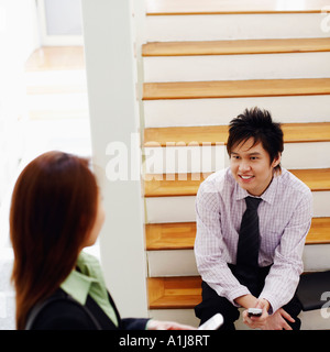 High angle view of a businesswoman talking to a woman smiling Banque D'Images