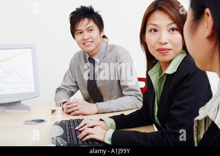 Close-up of business executives looking at each other and smiling Banque D'Images