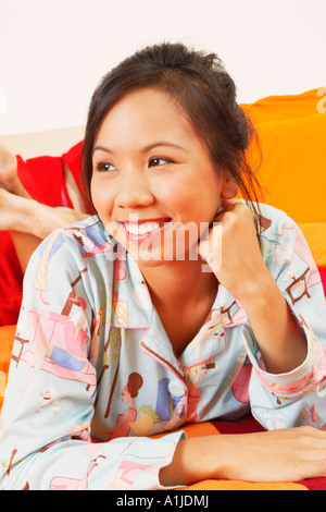 Close-up of a young woman lying on the bed and smiling Banque D'Images