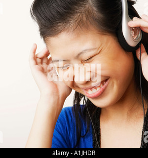 Close-up of a young woman wearing headphones et écouter de la musique Banque D'Images