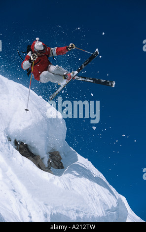 Skieur dans les airs au-dessus de la neige sur les pentes de ski Banque D'Images