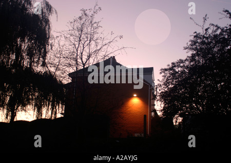 Paysage avec arbres silhouette,et un bâtiment avec un .Sécurité & Safe Light Allumé.prises dans le Staffordshire en Angleterre. Banque D'Images