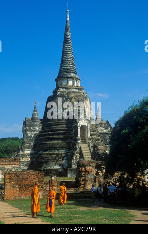 Moines en face d'un ancien Chedi dans les ruines du Wat Phra Si Sanphet à Ayutthaya en Thaïlande Banque D'Images