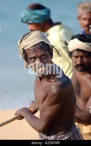 Transporter leurs filets de pêcheurs près de Poovar Island Beach Resort près de Trivandrum Kerala Inde Banque D'Images