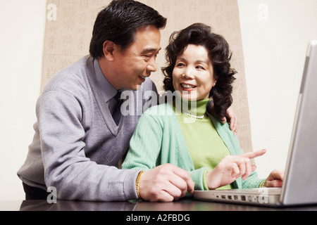 Low angle view of a young couple using a laptop Banque D'Images