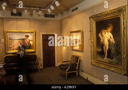 Marchand d'art années 1990 dans sa galerie avec des peintures Belgravia Art Gallery Londres Angleterre. 1999 UK HOMER SYKES Banque D'Images