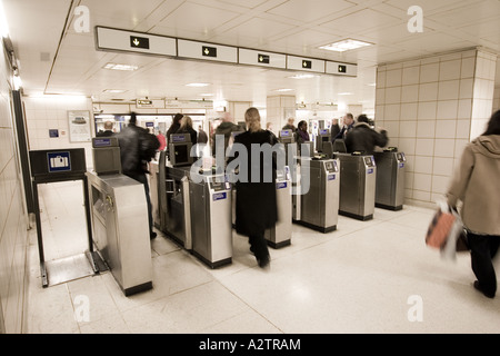 Les passagers en passant par les barrières automatique de billets à la station de métro Waterloo London England Banque D'Images