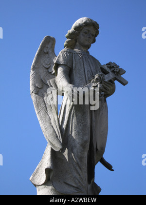 Angel avec croix d'armes et de ciel bleu derrière Southgate, cimetière de Londres England UK Banque D'Images